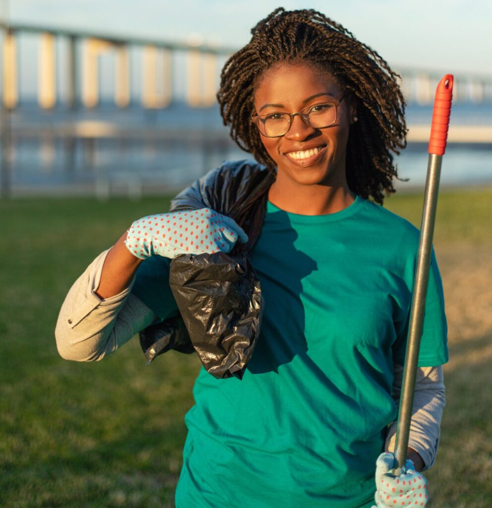 happy african american volunteer posing city park min